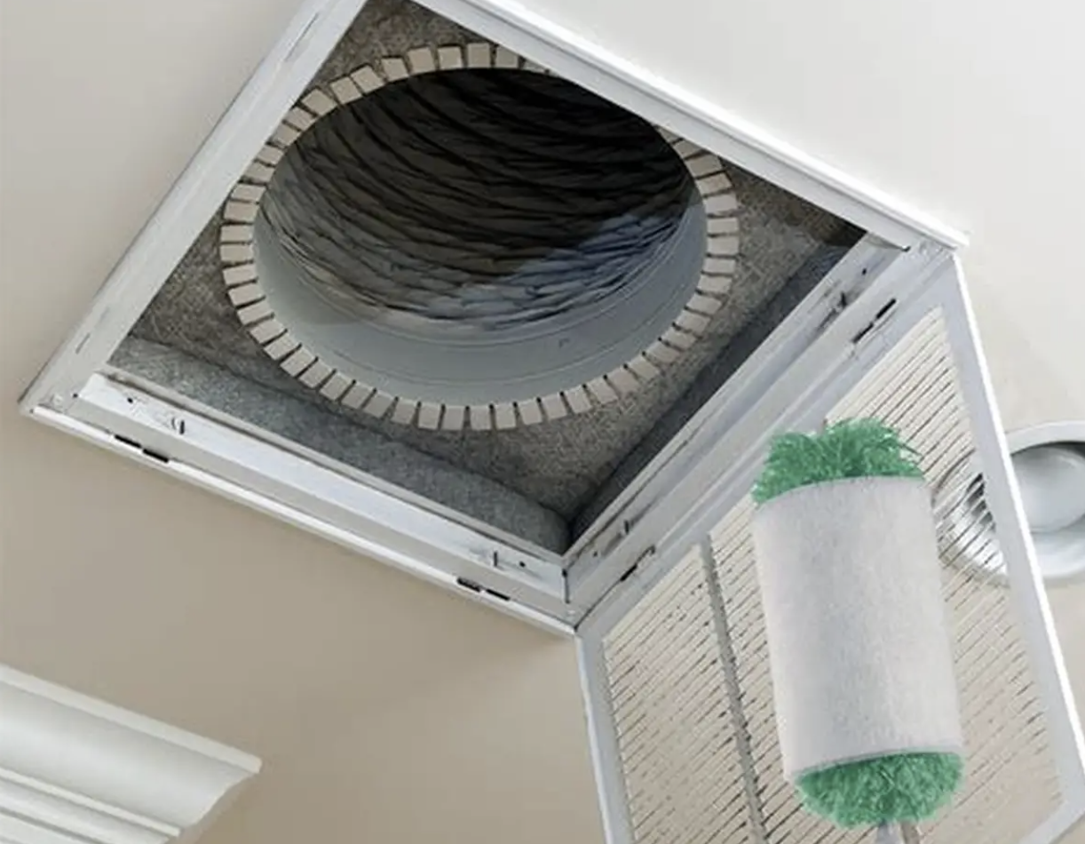 Rotary brush duct cleaning tool inside a ceiling air vent